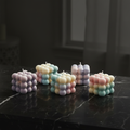 Pastel bubble cube soy wax candles on dark marble - hero shot